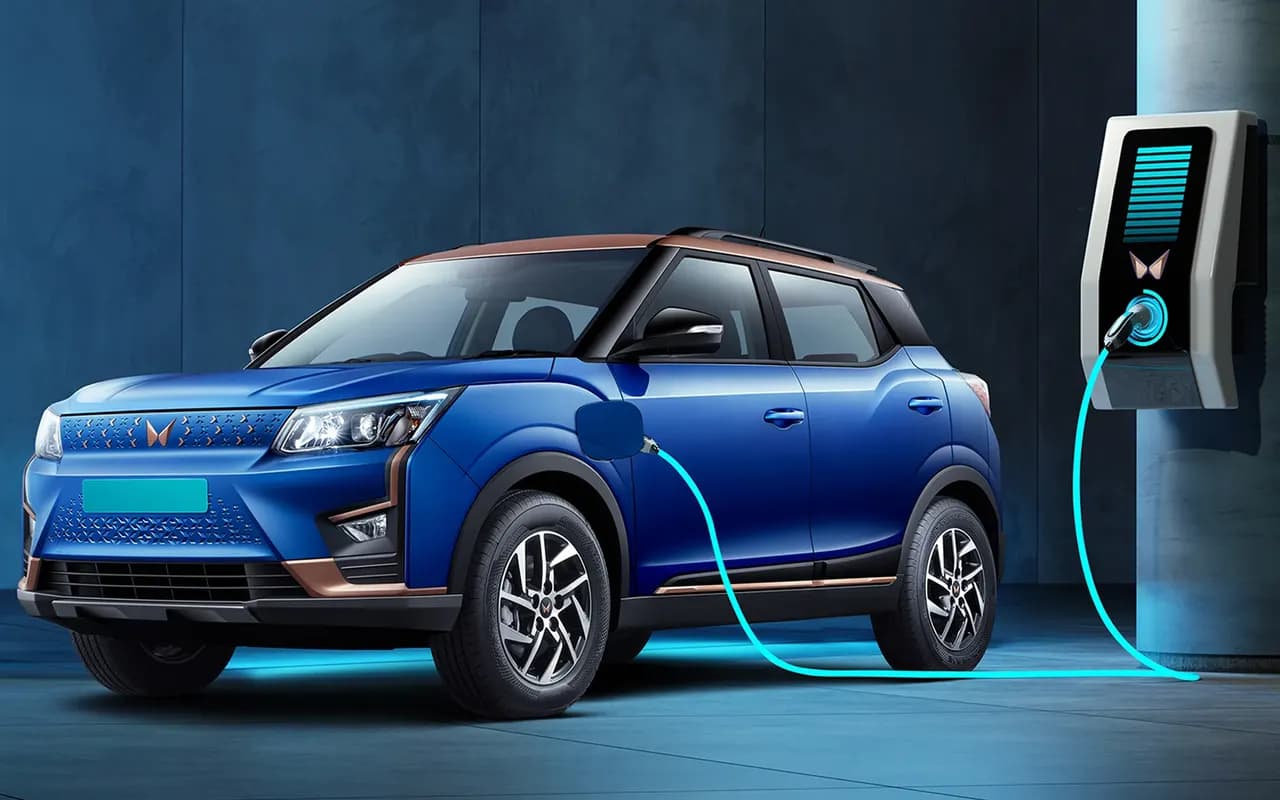 A Mahindra XUV400 plugged into a wall-mounted fast charger