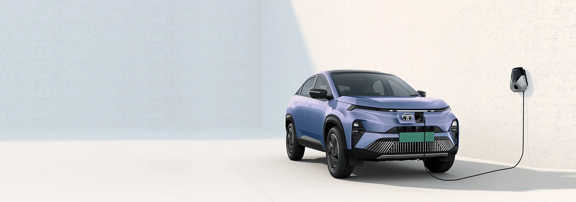 Tata Curvv.ev electric SUV charging from a wall charger